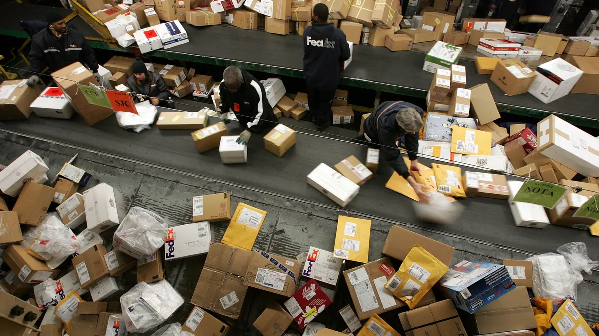 FedEx worker sort through a pile of boxes at the FedEx sort facility at the Oakland International Airport December 18, 2006 in Oakland, California.