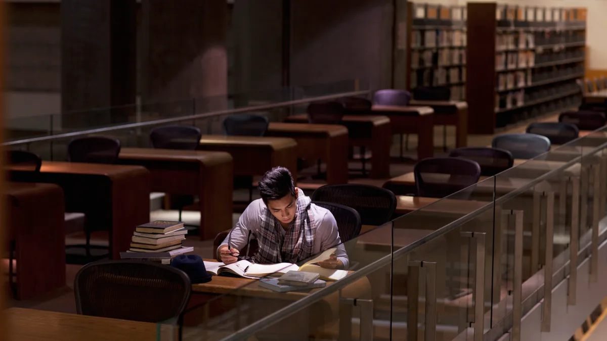 A college student pulls an all-nighter at the campus library