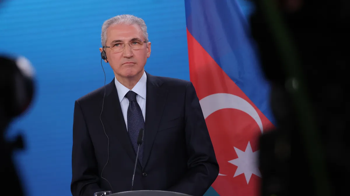 Mukhtar Babayev speaks to the media during a conference.