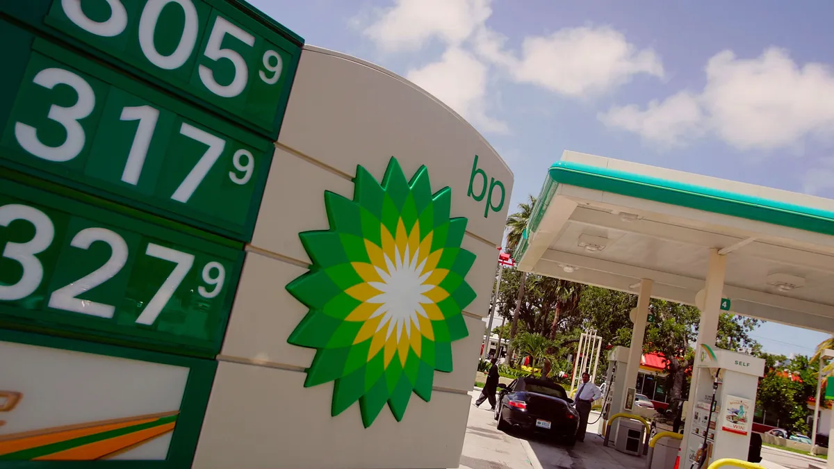 A BP sign displays prices at a gas station.