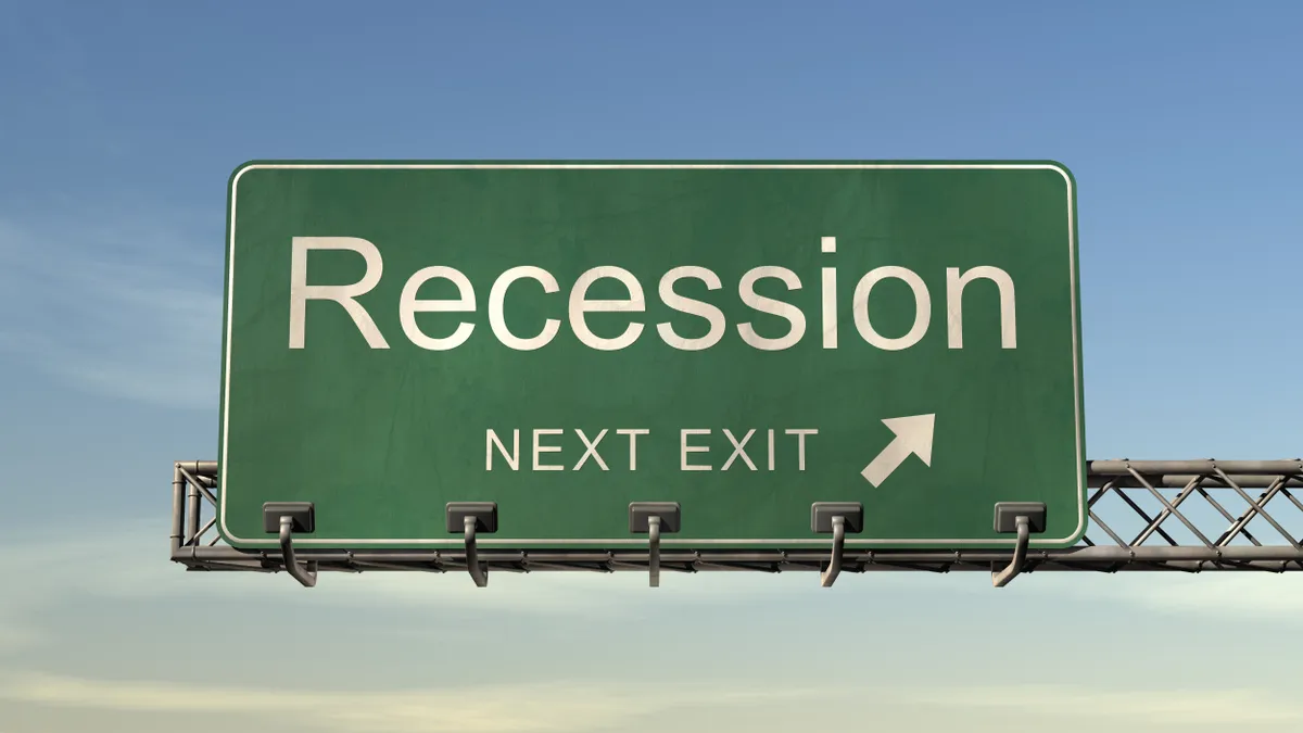 Highway sign with the word "recession next exit" on it.