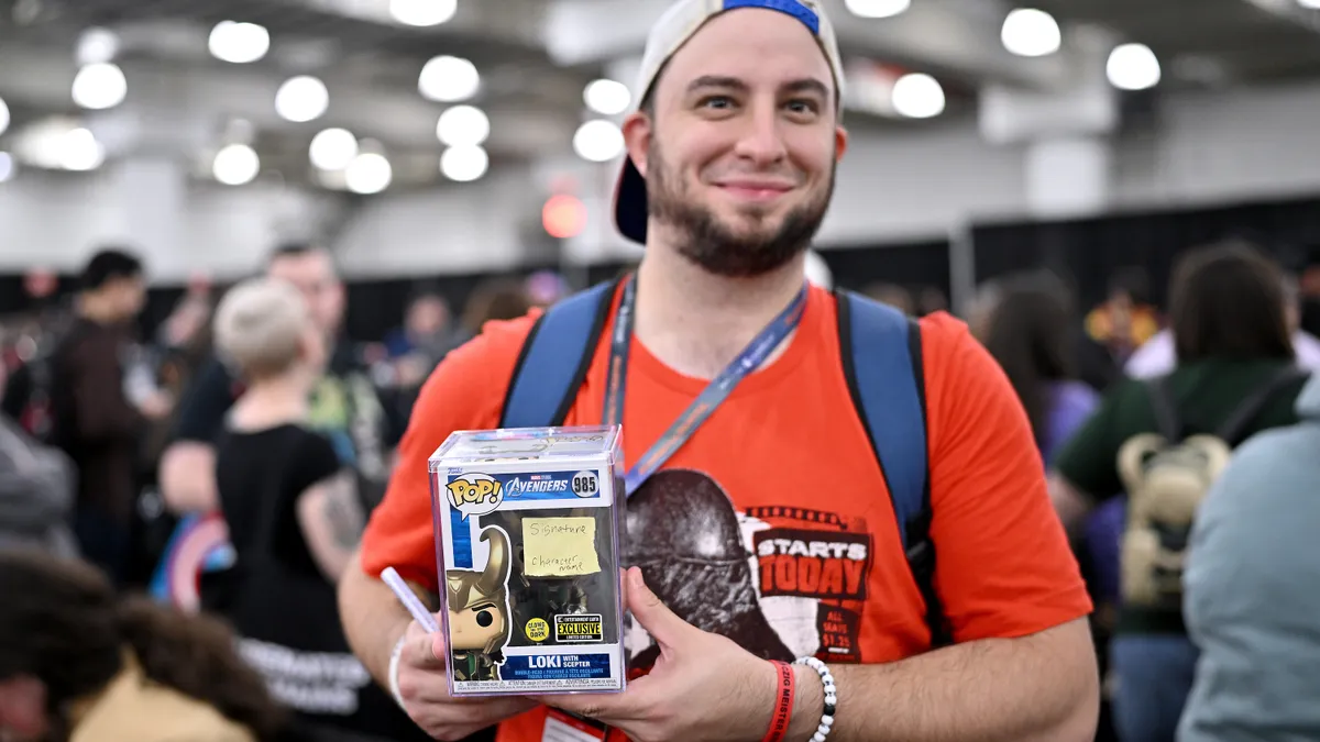 Comic Con attendee holding Funko Pop figure