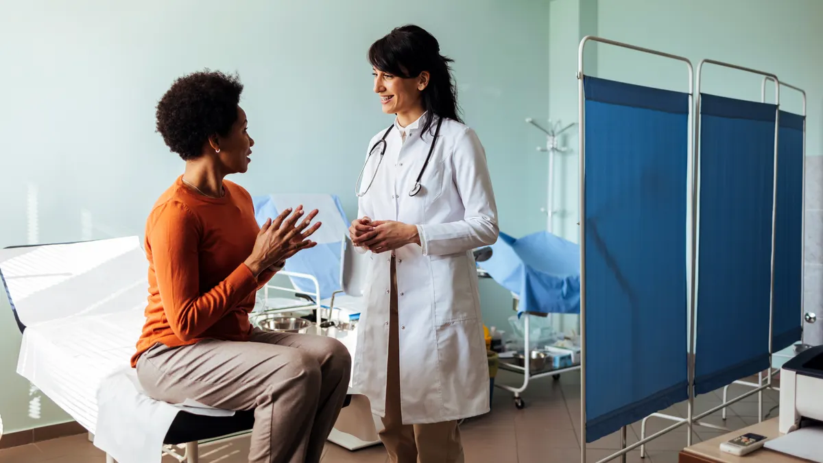 Doctor talking to a patient in a consultaton at the office.