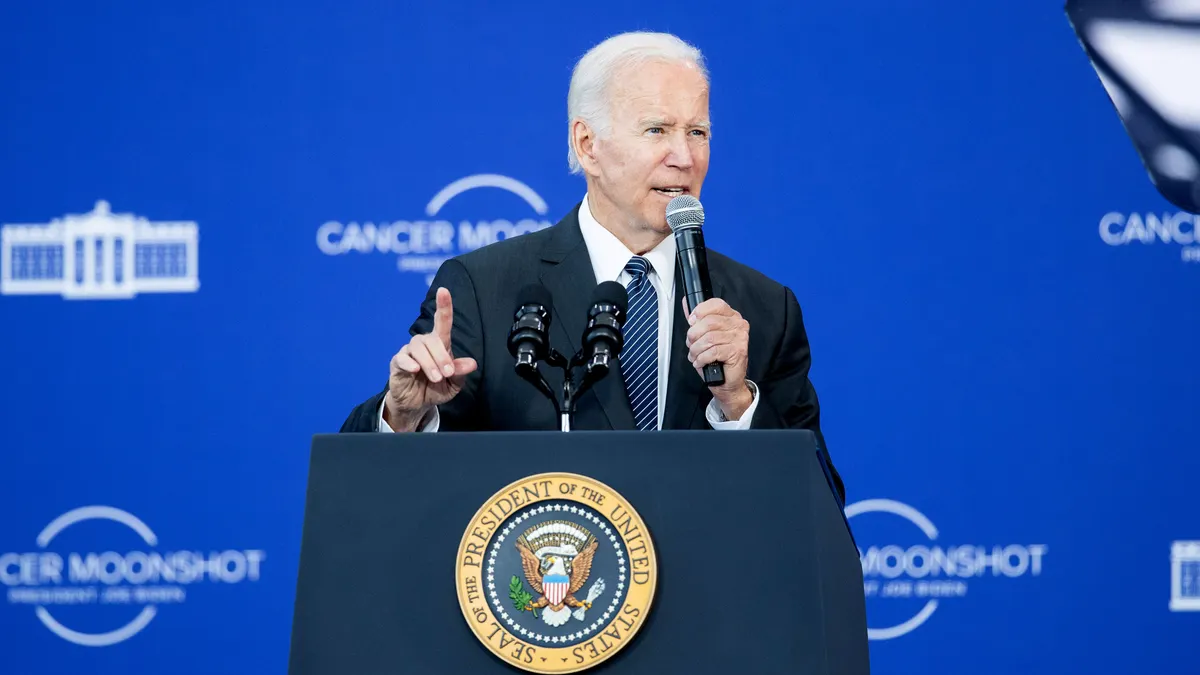 President Joe Biden delivers a speech from behind a podium.
