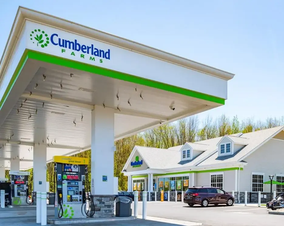 A photo of the exterior of a gas station and convenience store/ A sign on the fuel canopy says Cumberland Farms.