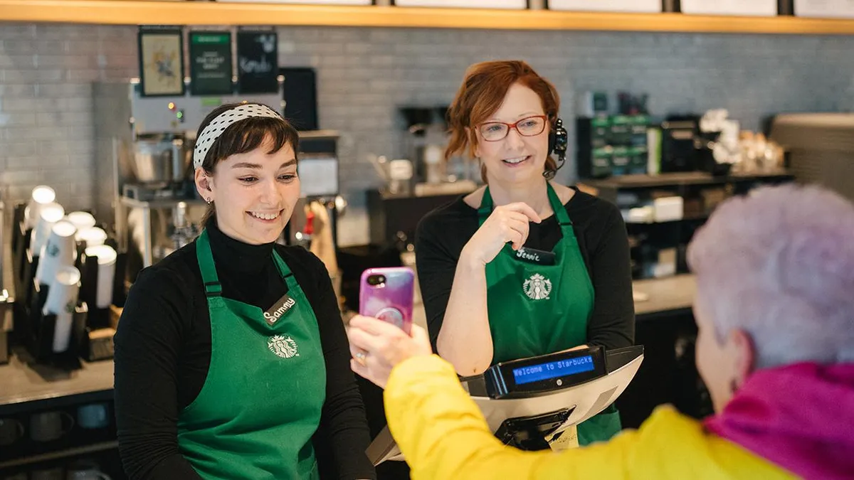 Person holds phone in Starbucks store