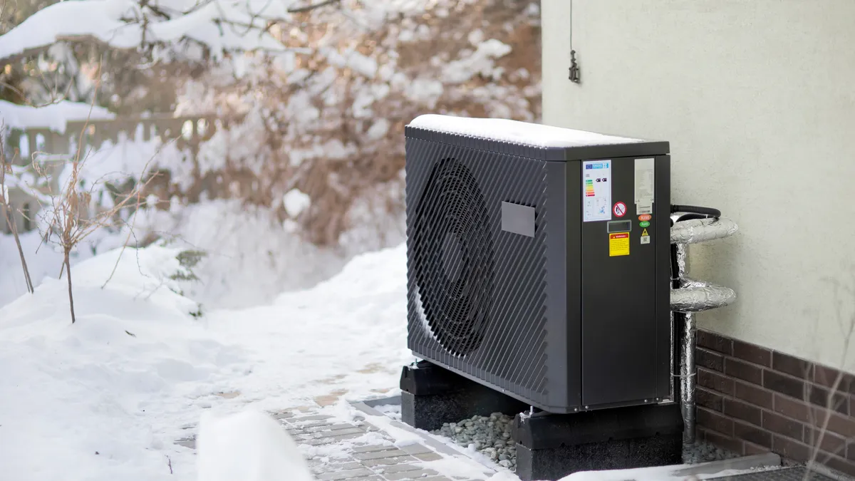 A modern heat pump in a cold, snowy setting