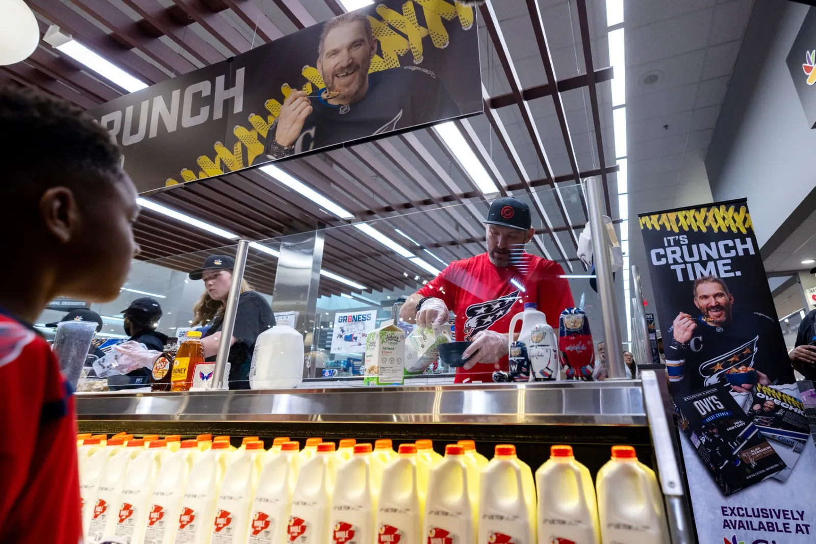 A hockey player doing a promotional event at a store.