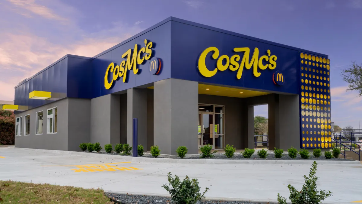 A exterior shot of the blue and yellow building with CosMc's signage