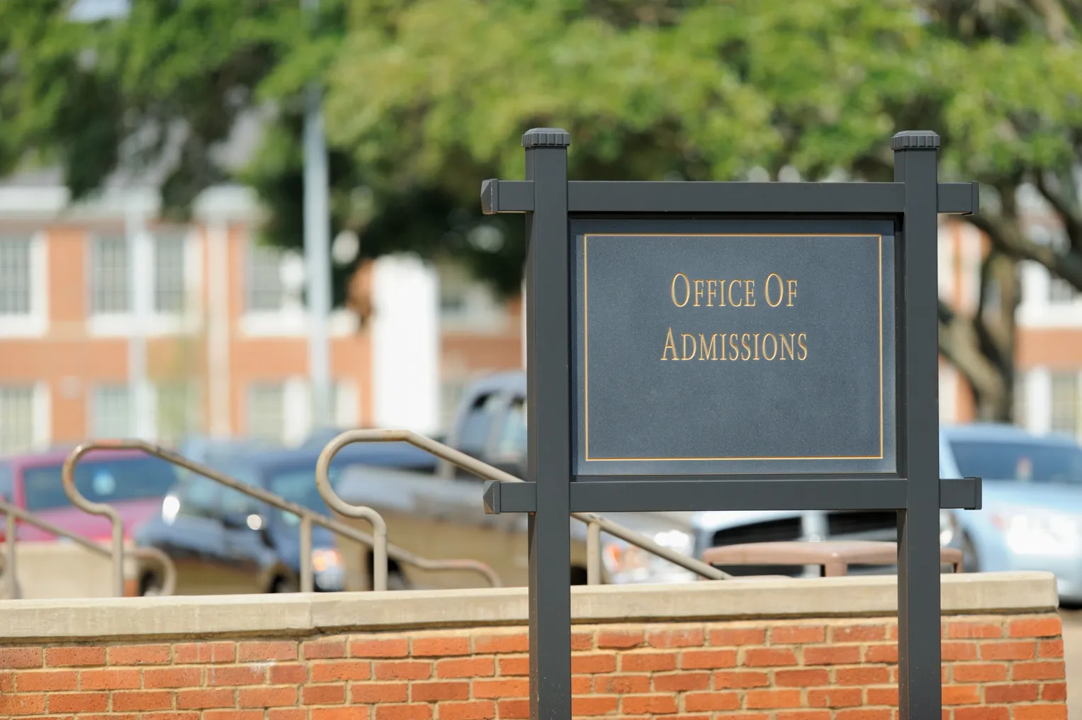 A sign advertises a college admissions office.