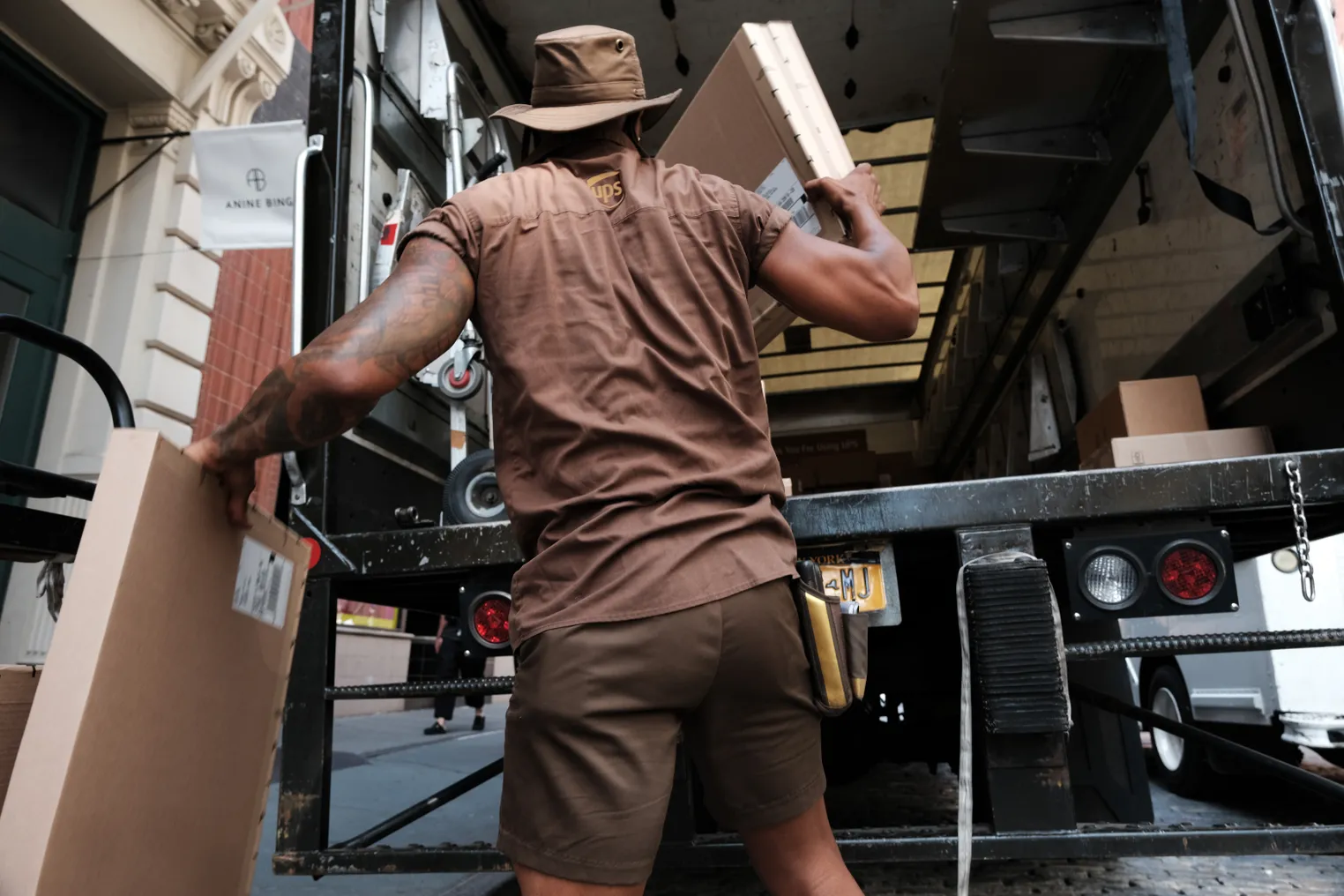 A UPS worker in Manhattan delivers packages on his daily rounds on July 24, 2023 in New York City.