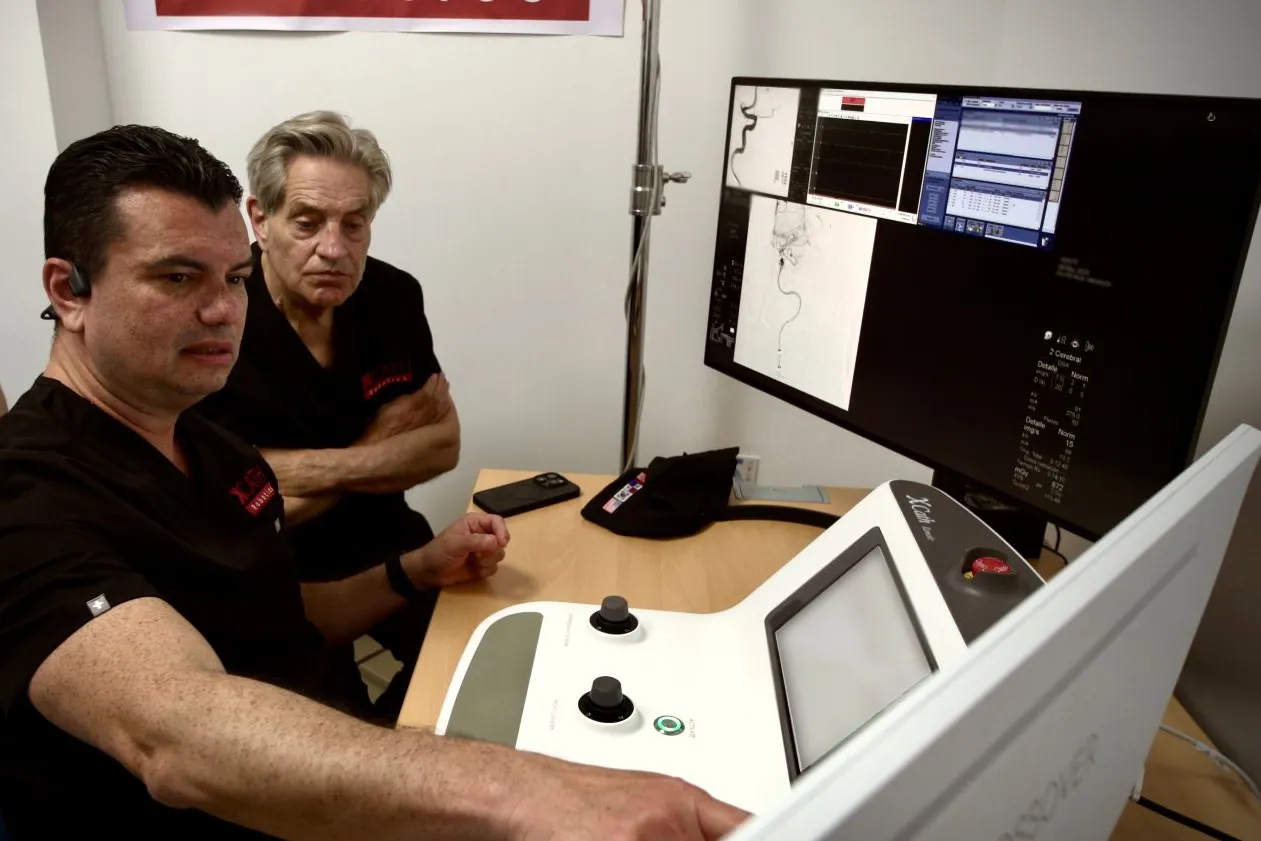 Neurosurgeon Vitor Mendes Pereira, left, with XCath Chairman Fred Moll, co-founder of Intuitive Surgical.