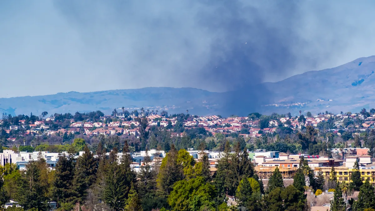 Smoke from a fire rising over residential areas in south San Jose, San Francisco bay area, California