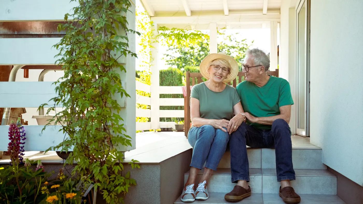 two people sitting on porch