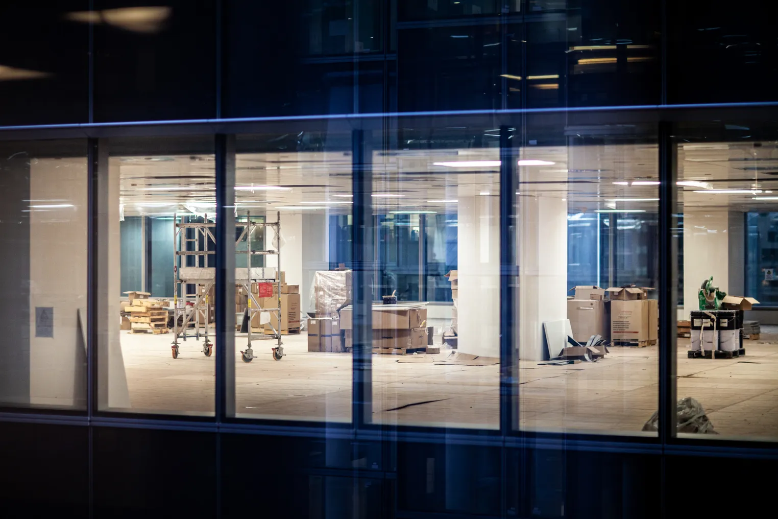 A view of windows that show renovation work in an office of a commercial building