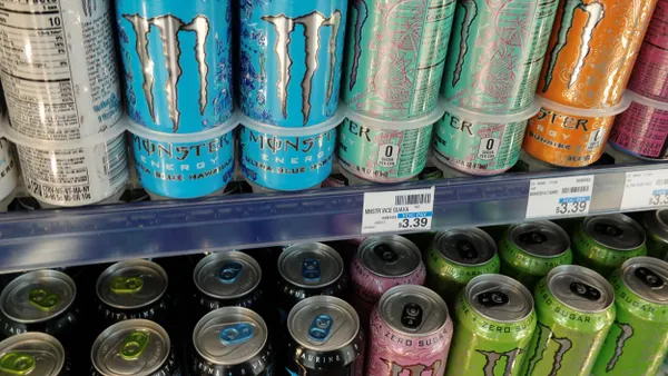 Cans of Monster are on a retail store shelf.