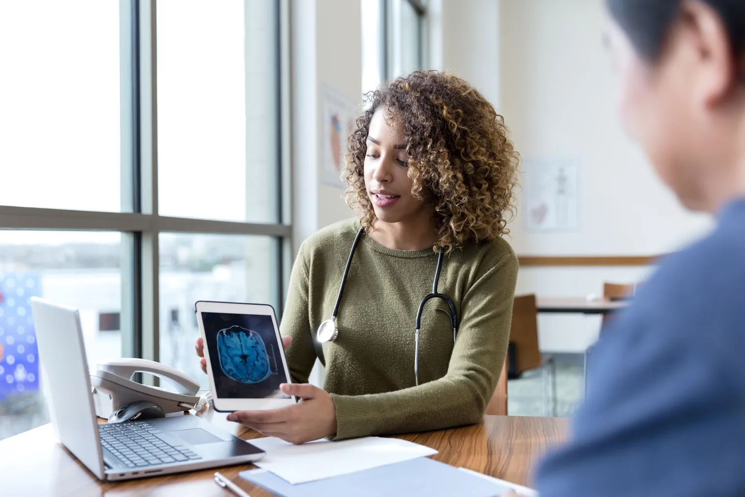 Neurologist discusses MRI scan with patient