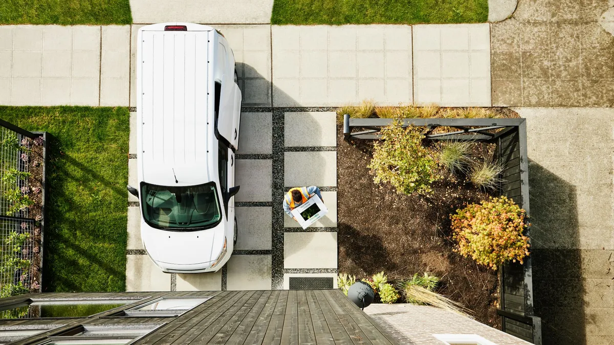 Overhead shot of person with delivery truck walking to door