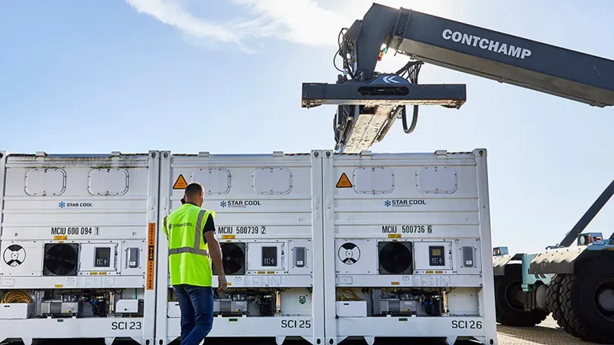 A line of refrigerated containers pictured below a Contchamp used to lift containers.