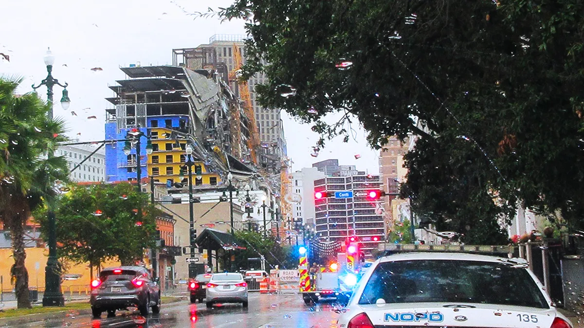 Emergency vehicles surround a partially collapsed building