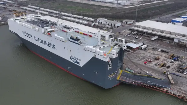 A cargo vessel specialized in handling auto units is docked at a Texas port.