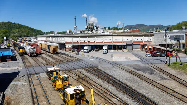 An industrial facility campus next to rail lines.