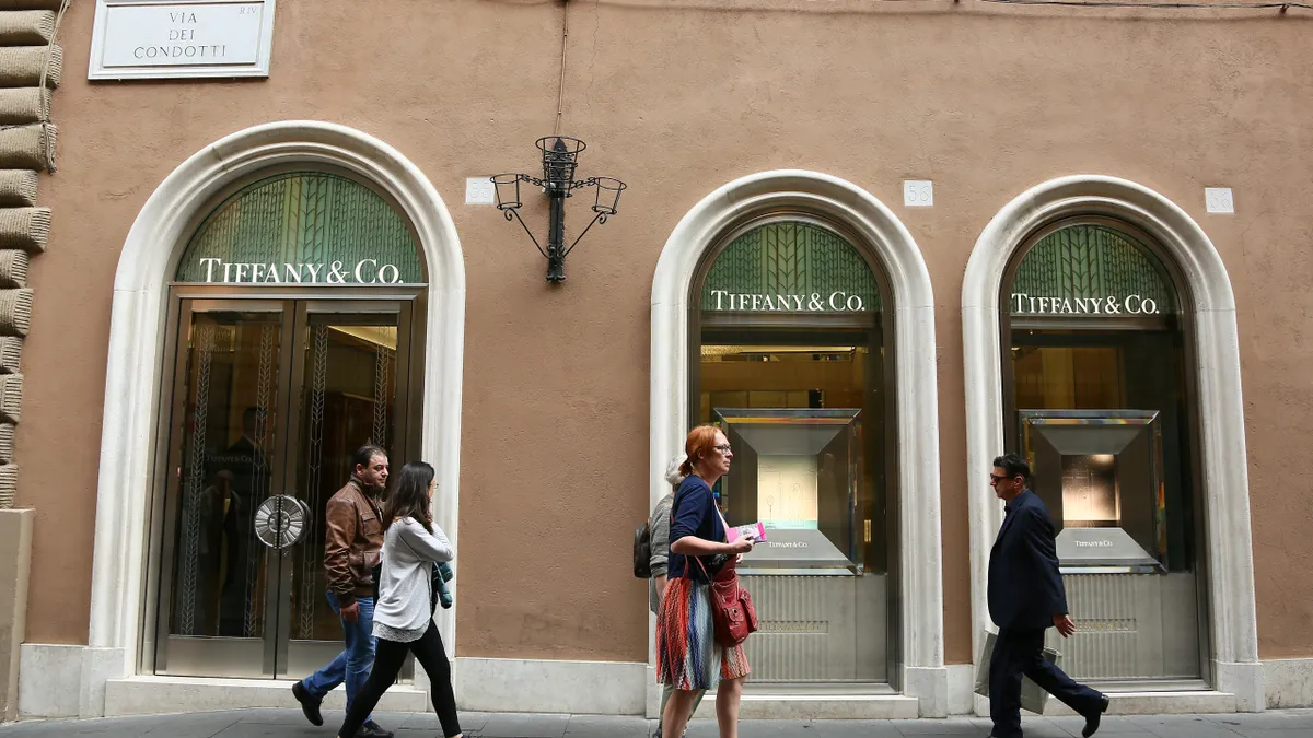 Patrons walk in front of the Tiffany & Co. store.