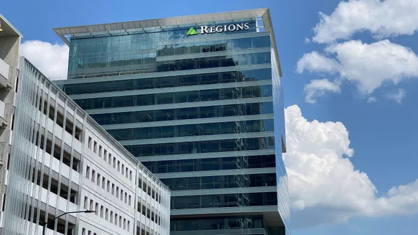 An office building with the word "Regions" at the top is shown against a blue sky.