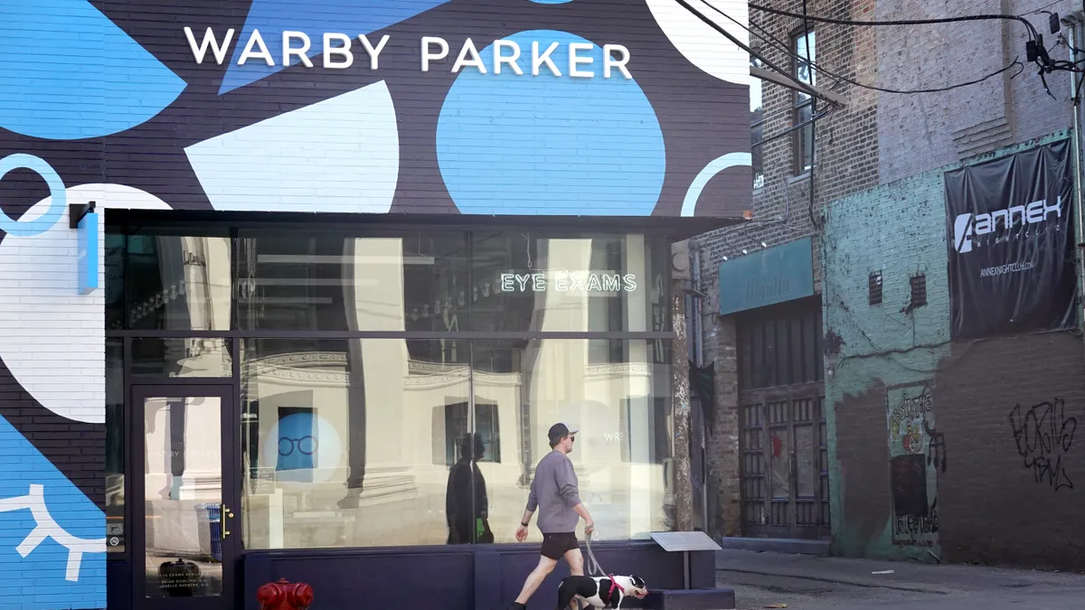 A sign marks the location of a Warby Parker store on September 29, 2021 in Chicago, Illinois.