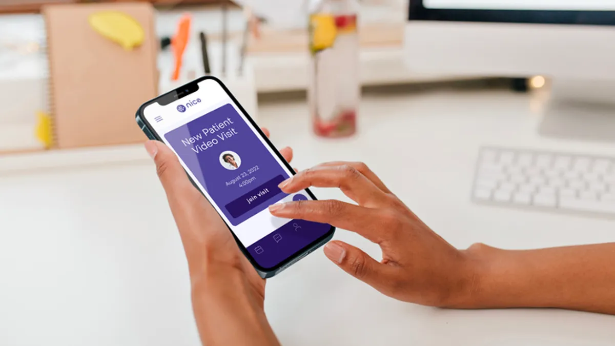 A person using the Nice Healthcare app on their phone.