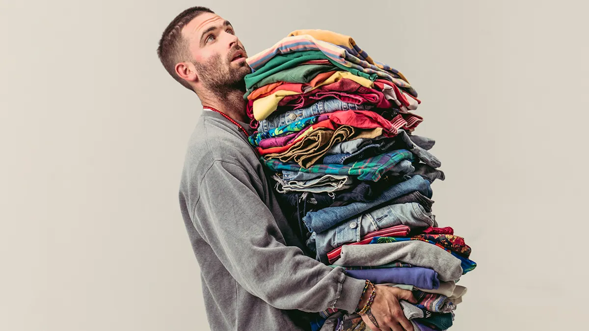 Sean Wotherspoon is seen holding a large pile of Gap clothes.