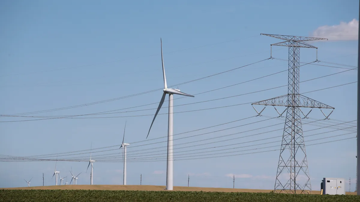 Power lines and power generating windmills rise above the rural landscape on June 13, 2018 near Dwight, Illinois.