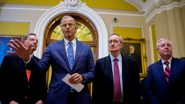 Senate Majority Leader John Thune, R-S.D., accompanied by Sen. John Barrasso, R-Wyo., Sen. Mike Crapo, R-Ind., and Sen. Lindsey Graham, R-S.C., speaks to reporters off the Senate floor after the Senate passed its megabill on July 1.
