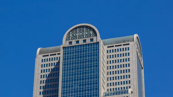 A tall building is shown with the word "Comerica" at the top.