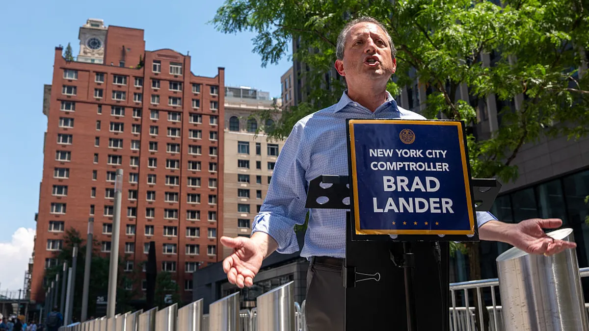 Brad Lander speaks at a podium outside of the Jacob K. Javitz Federal Building