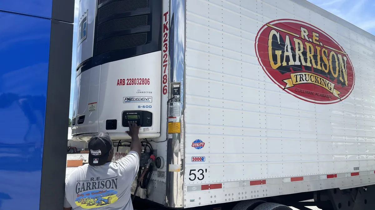 An R.E. Garrison worker interacts with a trailer's settings.