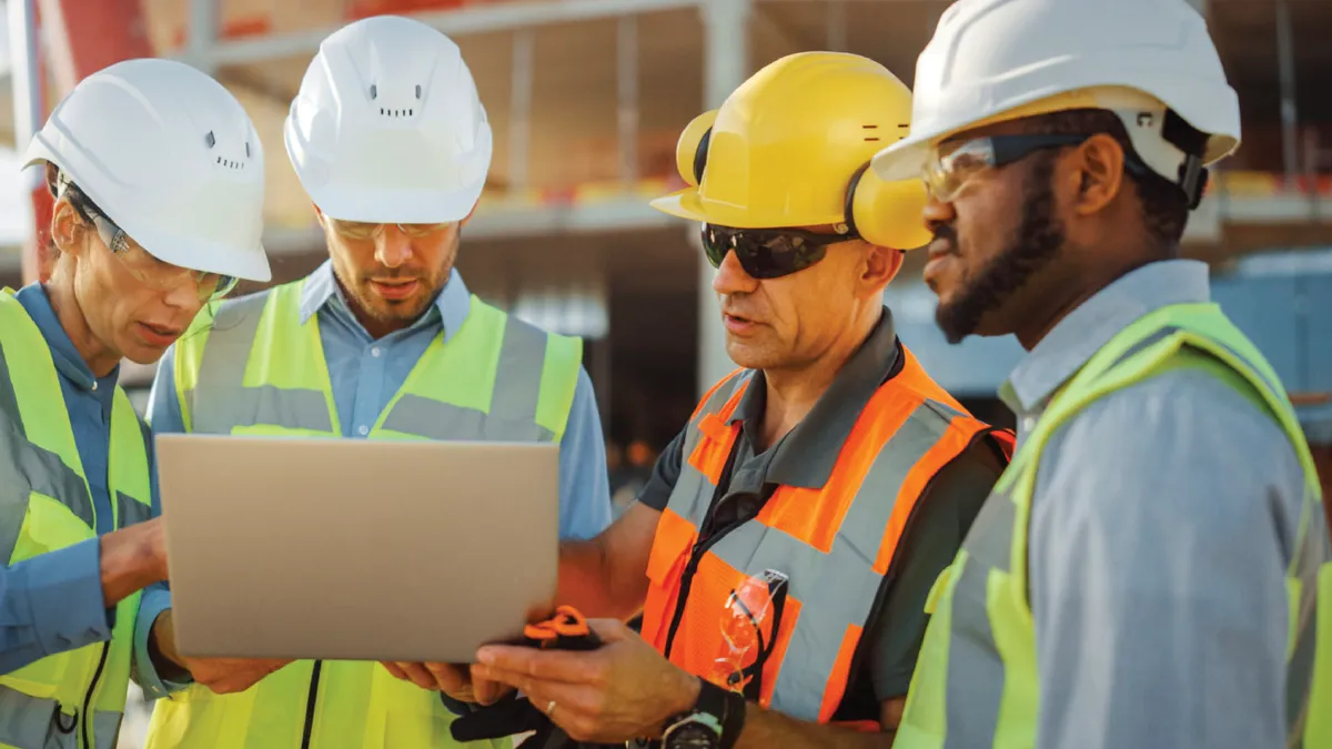 Team of specialists discussing plans on a construction site