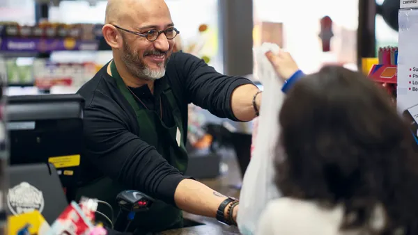 A young couple shopping in a small convenience store.