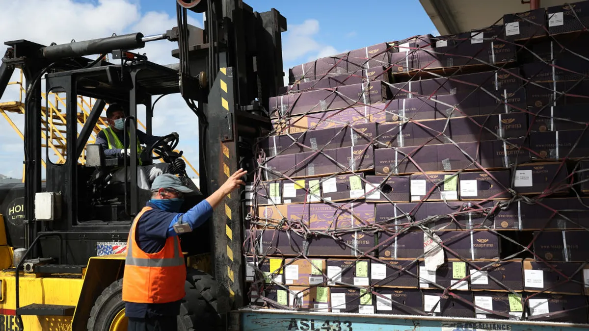 Boxes of flowers are moved on a forklift.