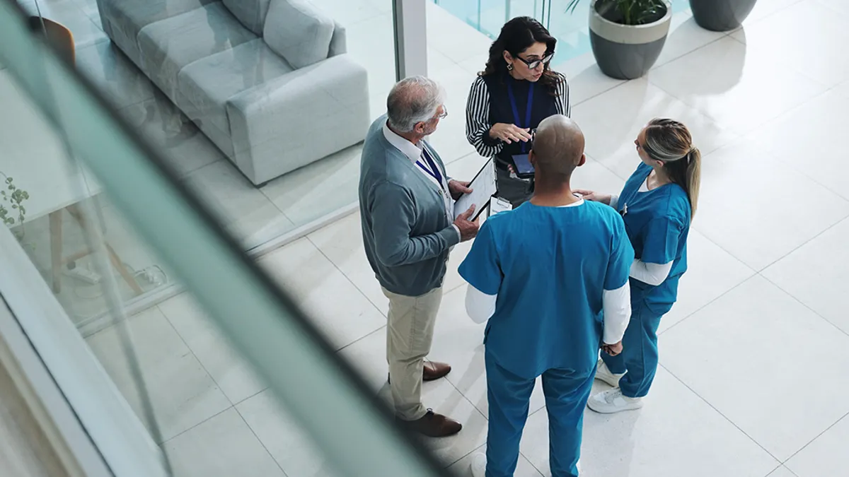 four people talking in a group
