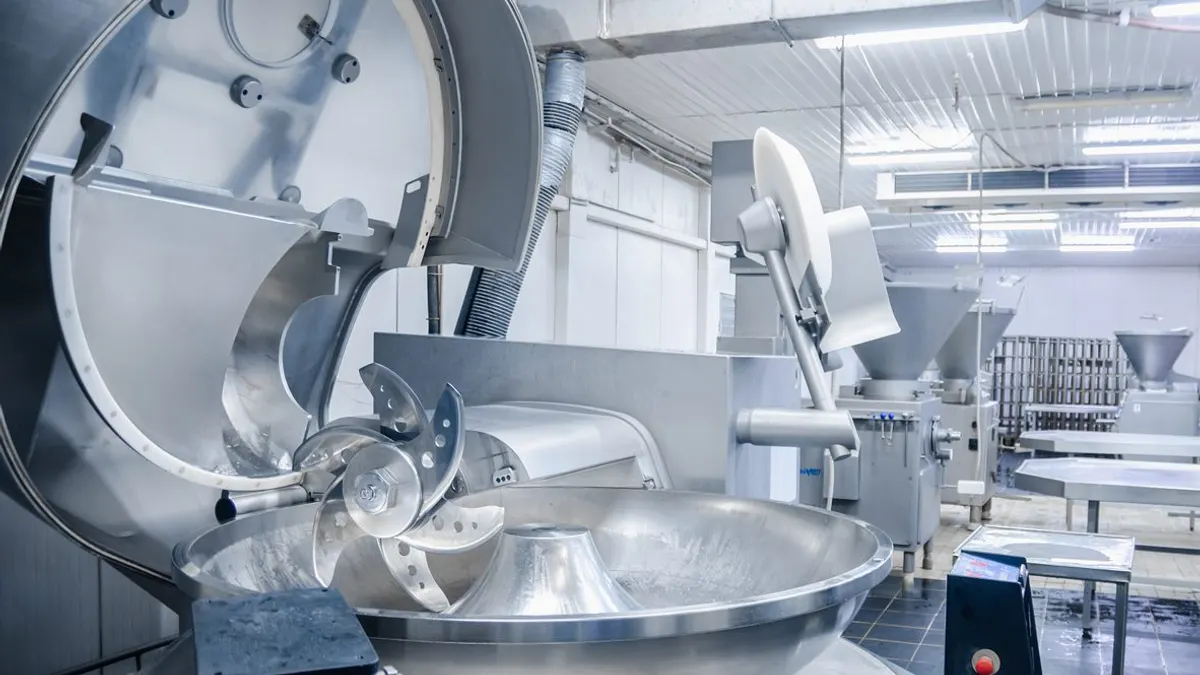 Industrial cutter for grinding meat. Factory for the production of sausages and meat delicacies.