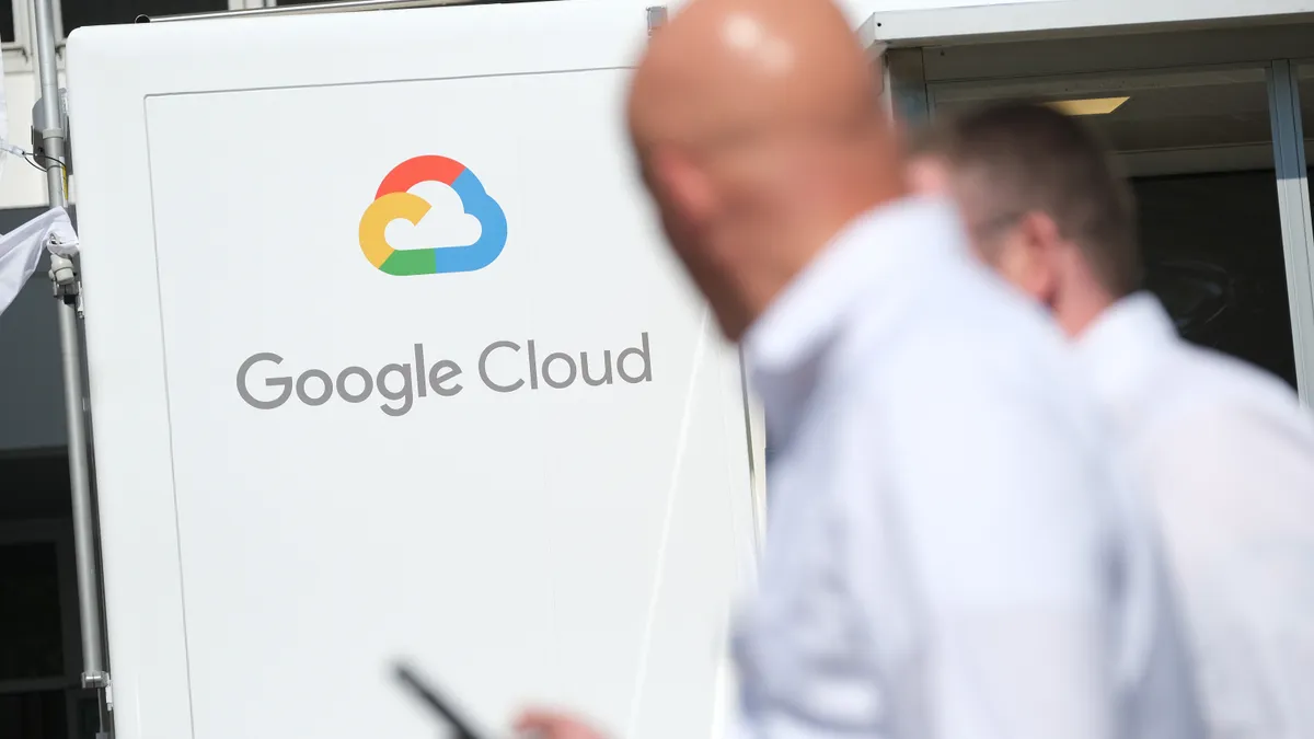 People walk past a Google Cloud exhibit during the press days at the 2019 IAA Frankfurt Auto Show on September 11, 2019.