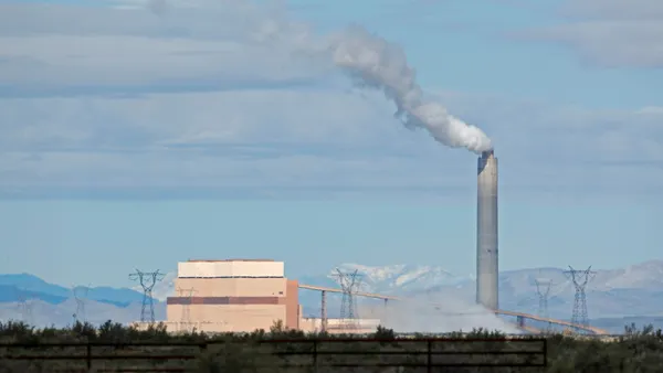 A power plant sits on a dry plain.
