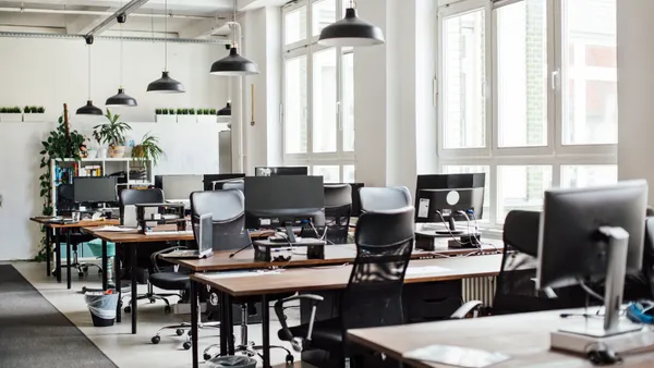 An empty office with monitors and other devices.