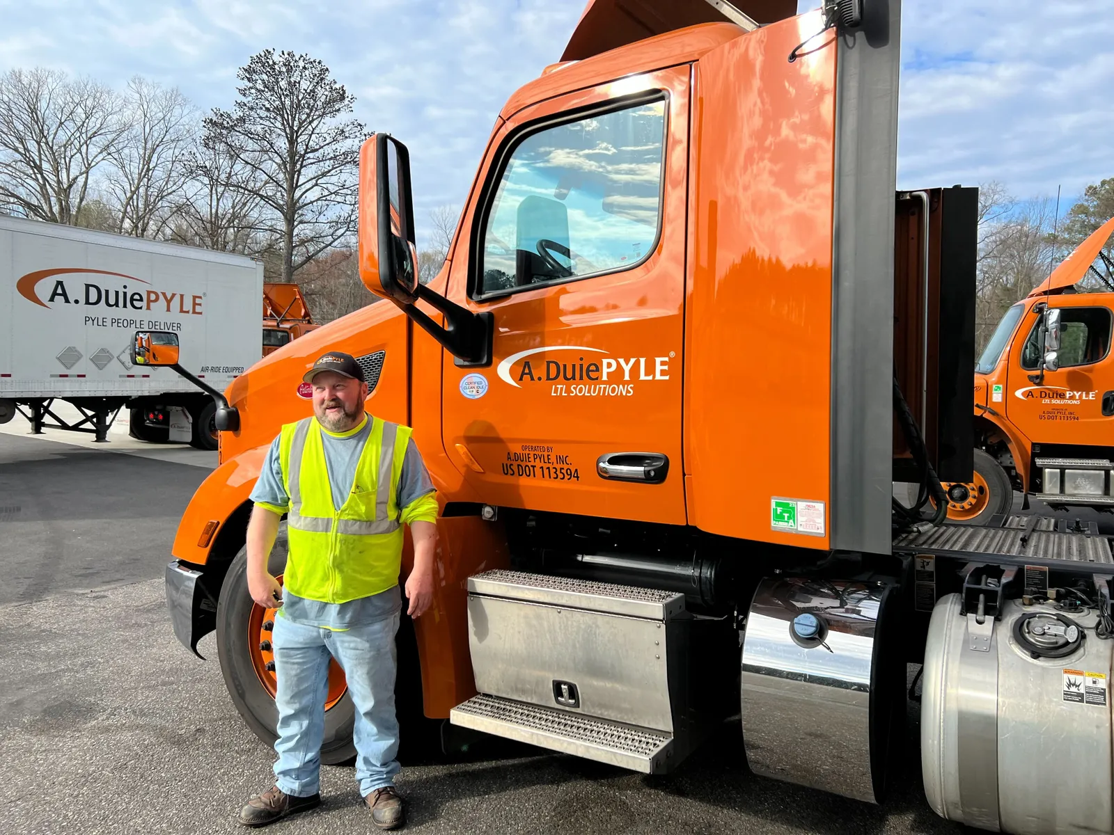 A. Duie Pyle driver David Johnson stands in front of his truck. He was the first driver hired when the company's Richmond, Virginia terminal opened in April 2022.