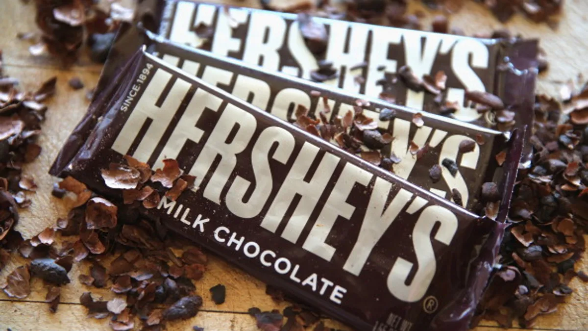 Photo of Hershey chocolate bars and flakes of chocolate beneath the packages