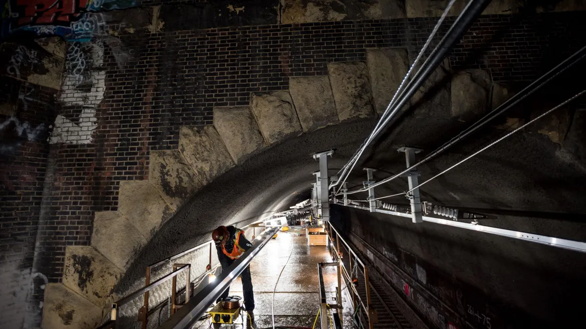 A construction worker inside a tunnel.