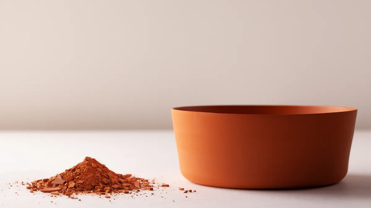 A clay bowl next to its base clay material or "dust."