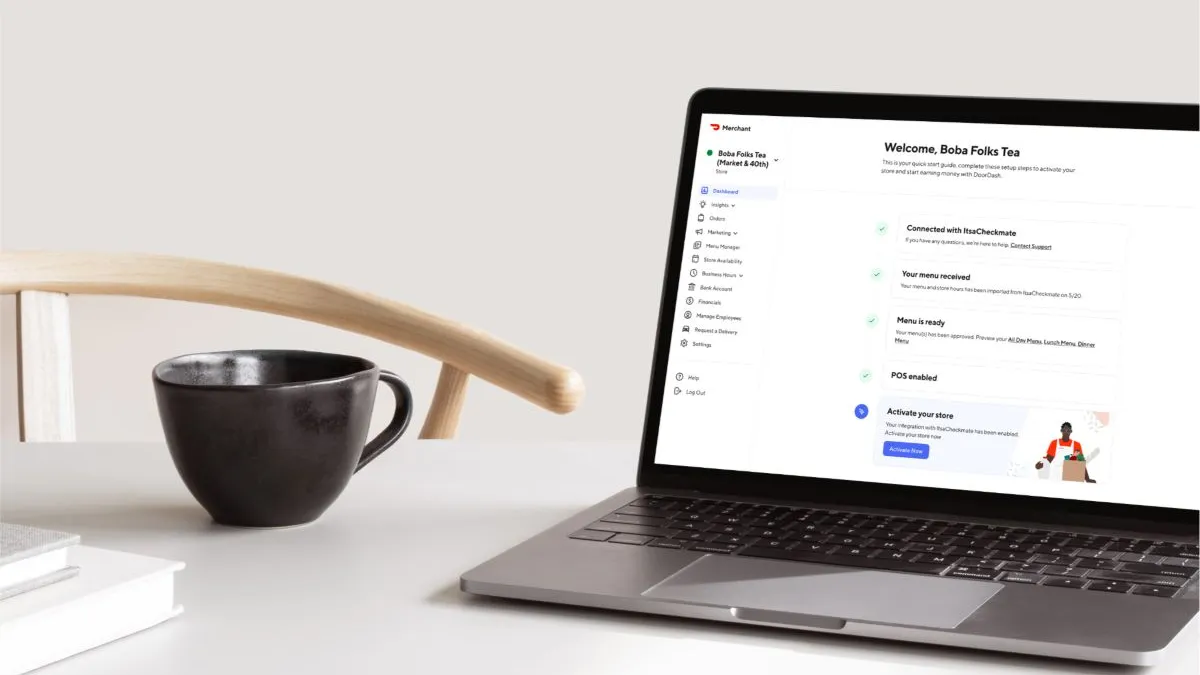 A table with a laptop that has features from DoorDash.
