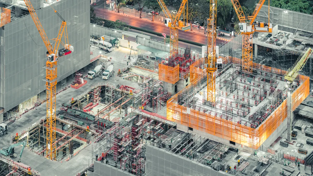 An overhead shot shows a large commercial construction project.